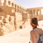 Traveler exploring the ancient ruins at Karnak Temple in Luxor, Egypt.